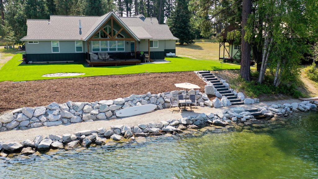 backyard area over a river with a lush green lawn